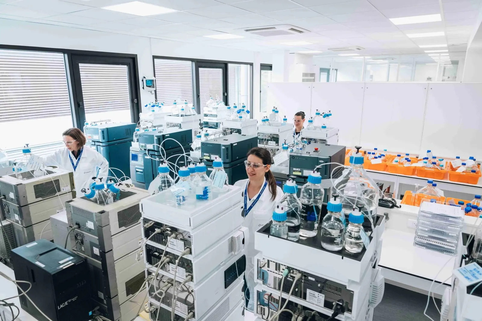 Eurofins laboratory — chemists analysing water samples on HPLC instruments